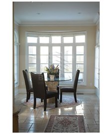Bow windows next to a dinner table