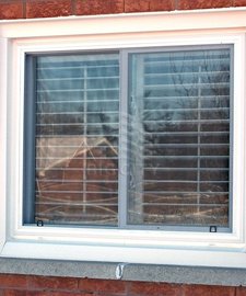 Double slider tilt window around a brick wall