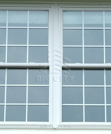 Single hug tilt window within a house