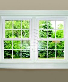 Single hung tilt windows in a beige house