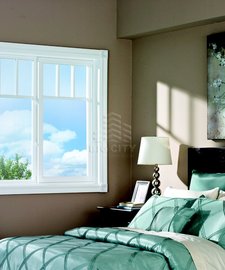 Single slider tilt window in an adult's bedroom