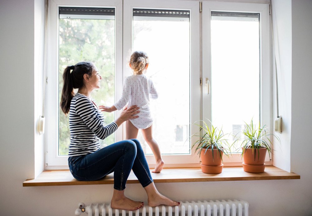 Mother and child in front of vinyl windows
